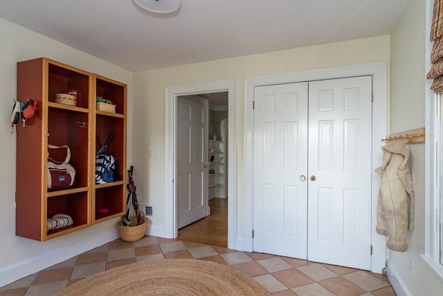 bedroom featuring a closet and baseboards
