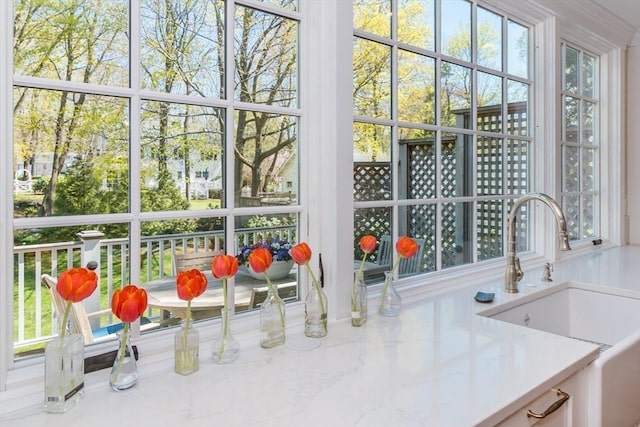 sunroom / solarium featuring a sink