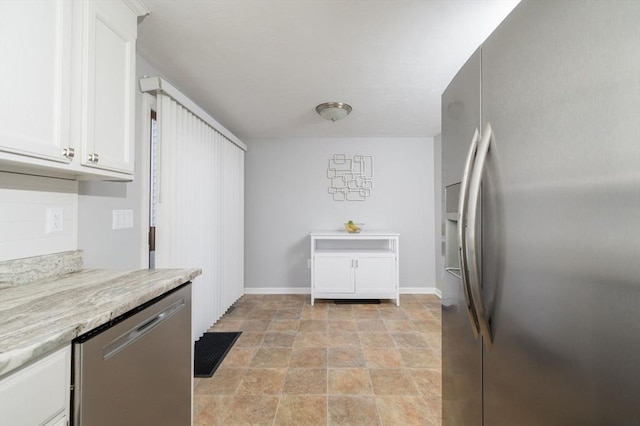 kitchen featuring white cabinetry, appliances with stainless steel finishes, and light stone countertops