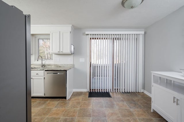 kitchen with sink, stainless steel appliances, tasteful backsplash, light stone countertops, and white cabinets