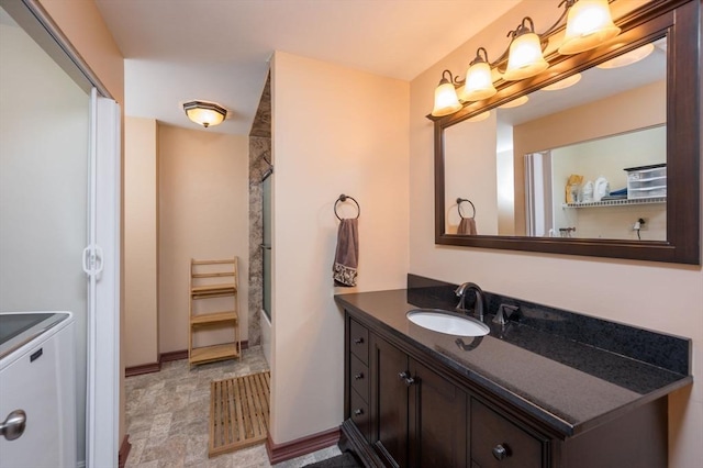 bathroom with vanity and enclosed tub / shower combo