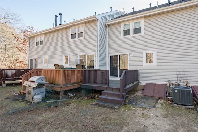 rear view of property with a wooden deck and central AC unit