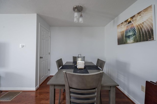 dining space featuring dark hardwood / wood-style flooring