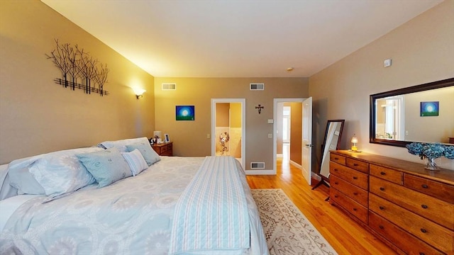 bedroom featuring light wood-style flooring and baseboards