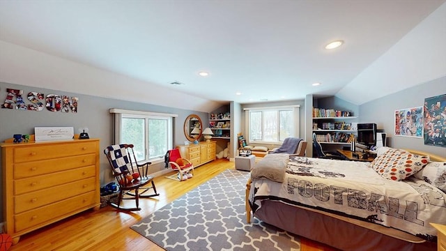 bedroom featuring lofted ceiling, multiple windows, light wood-type flooring, and recessed lighting