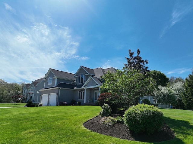 view of front of property featuring a garage and a front lawn