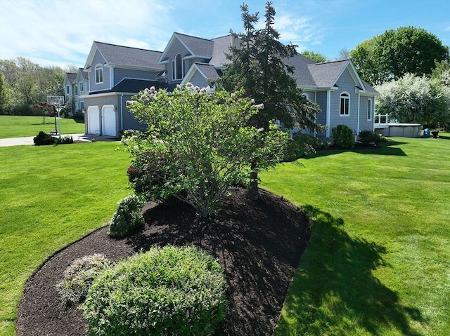 view of side of home featuring an attached garage and a lawn