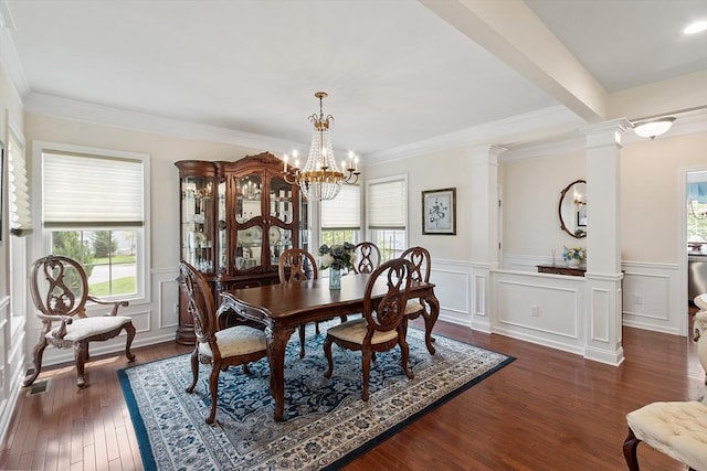123 Skyline Dr Unit 123, Acton, MA 01720 - dining area featuring healthy amount of natural light, ornate columns, a chandelier, a wainscoted wall, and dark wood-style flooring