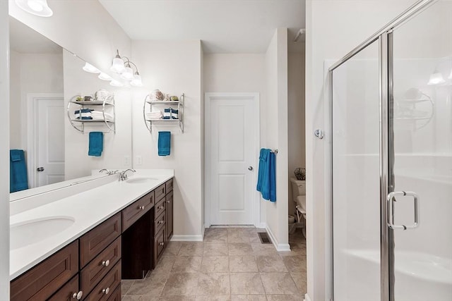 123 Skyline Dr Unit 123, Acton, MA 01720 - full bathroom with double vanity, a shower stall, baseboards, and toilet