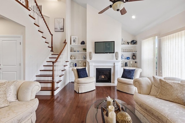 123 Skyline Dr Unit 123, Acton, MA 01720 - living room featuring stairway, a ceiling fan, dark wood finished floors, high vaulted ceiling, and a glass covered fireplace
