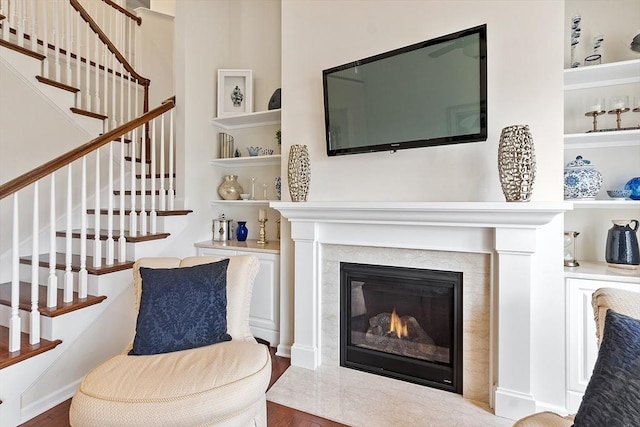123 Skyline Dr Unit 123, Acton, MA 01720 - living area with wood finished floors, stairway, and a fireplace with flush hearth