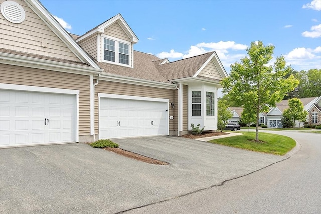 123 Skyline Dr Unit 123, Acton, MA 01720 - view of front of home featuring driveway and roof with shingles