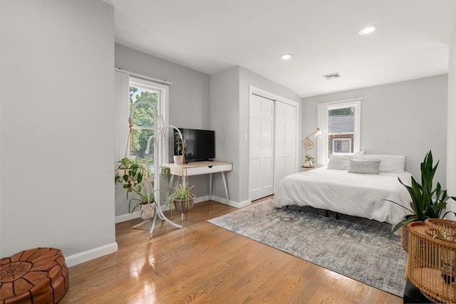 21 Glenley Ter, Boston, MA 02135 - bedroom featuring multiple windows, wood finished floors, a closet, and recessed lighting