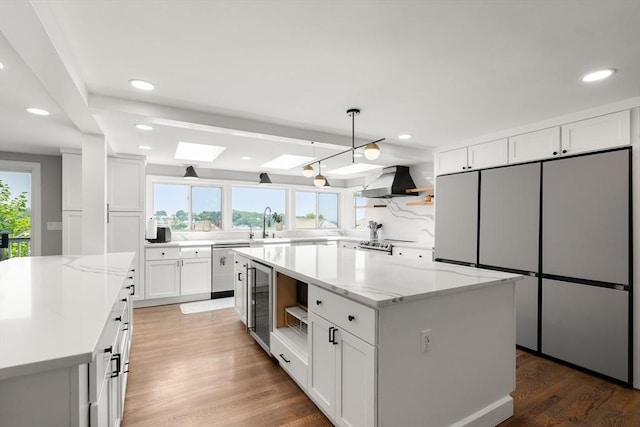 21 Glenley Ter, Boston, MA 02135 - kitchen with open shelves, wine cooler, freestanding refrigerator, wall chimney exhaust hood, and a kitchen island