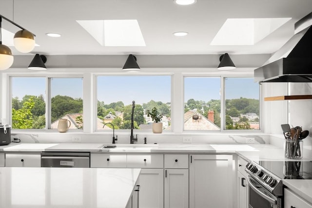 21 Glenley Ter, Boston, MA 02135 - kitchen with a skylight, wall chimney range hood, stainless steel appliances, plenty of natural light, and recessed lighting