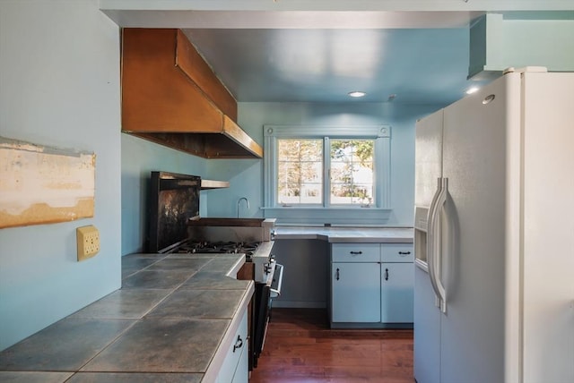41 Bulkley, Williamstown, MA 01267 - kitchen featuring white fridge with ice dispenser, gas range, premium range hood, tile counters, and white cabinets
