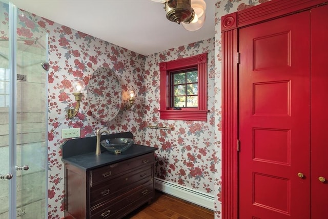41 Bulkley, Williamstown, MA 01267 - full bath featuring wallpapered walls, wood finished floors, baseboards, baseboard heating, and vanity