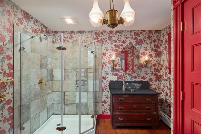 41 Bulkley, Williamstown, MA 01267 - full bath featuring wallpapered walls, wood finished floors, a stall shower, vanity, and baseboard heating