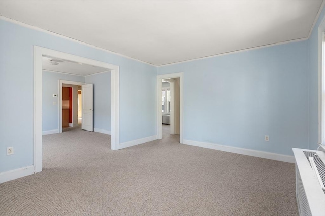 unfurnished room with baseboards, visible vents, and light carpet