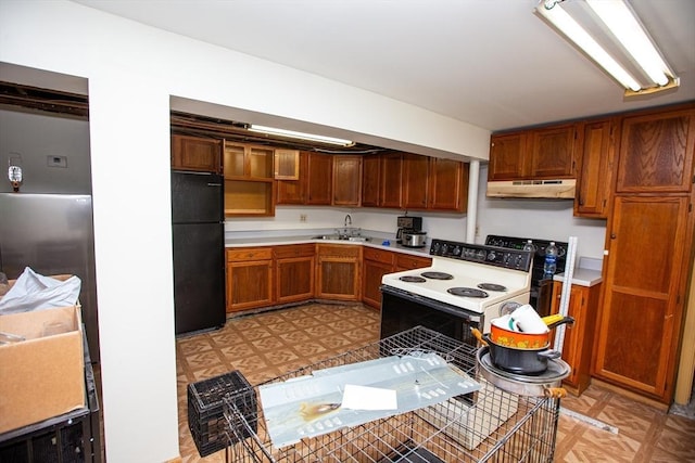 166 Fairview Ave, Rehoboth, MA 02769 - kitchen with freestanding refrigerator, white electric range oven, under cabinet range hood, a sink, and light countertops