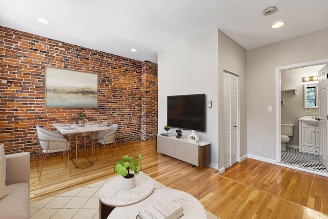 16 Foster St Unit 5, Boston, MA 02109 - living area featuring wood finished floors, brick wall, and recessed lighting