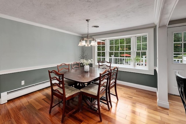 7 Perkins Row, Topsfield, MA 01983 - dining room with baseboard heating, a chandelier, a textured ceiling, crown molding, and light wood finished floors