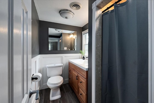7 Perkins Row, Topsfield, MA 01983 - full bath featuring vanity, wood finished floors, a shower with shower curtain, wainscoting, and a decorative wall