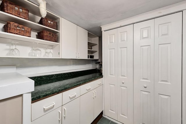 7 Perkins Row, Topsfield, MA 01983 - kitchen with open shelves, white cabinetry, and dark tile patterned floors