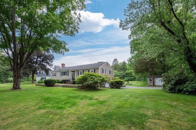 7 Perkins Row, Topsfield, MA 01983 - view of front of home featuring a chimney, a front yard, and an outbuilding