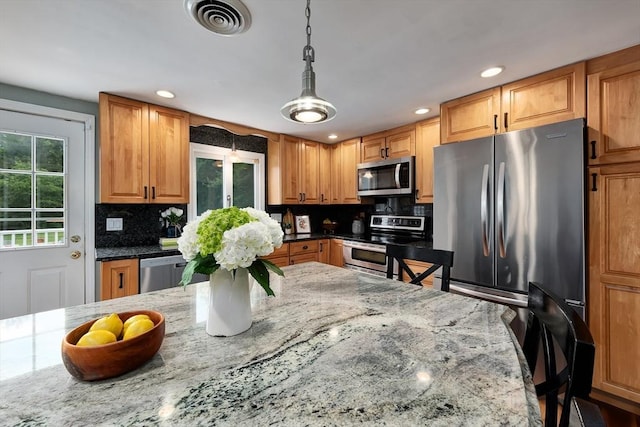 7 Perkins Row, Topsfield, MA 01983 - kitchen featuring stainless steel appliances, light stone countertops, tasteful backsplash, recessed lighting, and hanging light fixtures