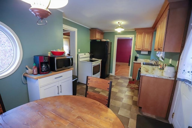 kitchen with stainless steel microwave, ornamental molding, light countertops, white electric range, and a sink