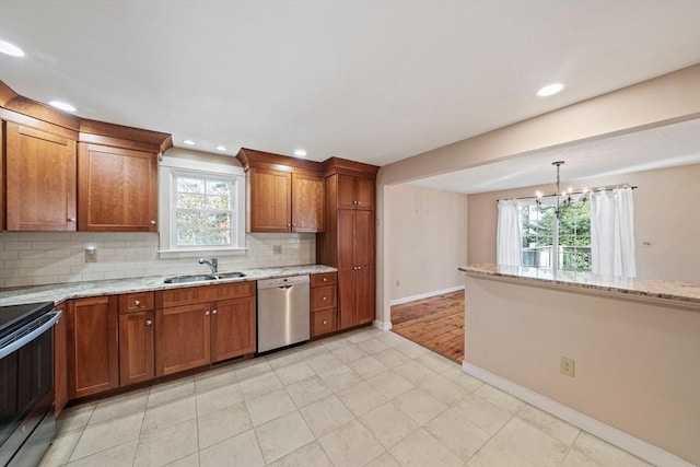 kitchen featuring electric range, stainless steel dishwasher, a sink, and brown cabinets