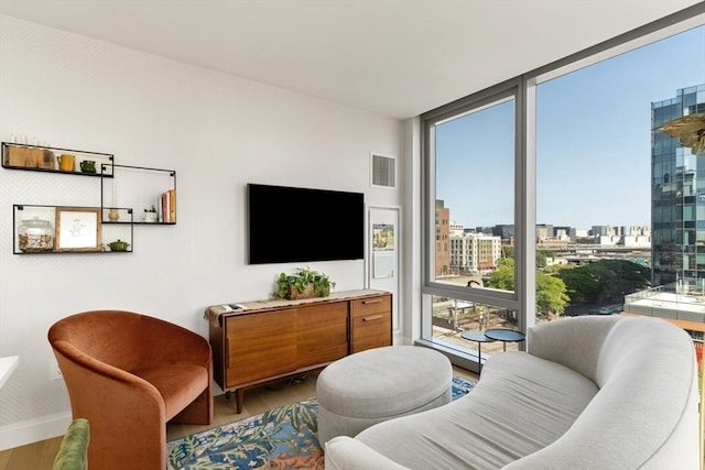 living room featuring hardwood / wood-style flooring and a wall of windows