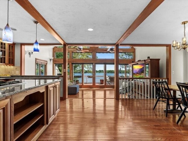 91 Lake Shore Dr, West Brookfield, MA 01585 - kitchen featuring open shelves, hardwood / wood-style flooring, stainless steel gas cooktop, ceiling fan, and beam ceiling