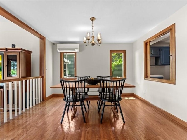 91 Lake Shore Dr, West Brookfield, MA 01585 - dining room featuring a wall mounted air conditioner, a chandelier, hardwood / wood-style floors, and baseboards