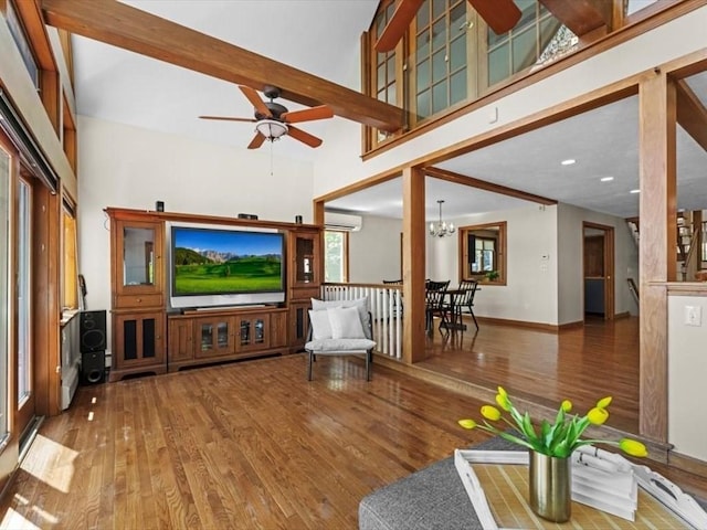 91 Lake Shore Dr, West Brookfield, MA 01585 - living room featuring a ceiling fan, an AC wall unit, wood finished floors, healthy amount of natural light, and a high ceiling