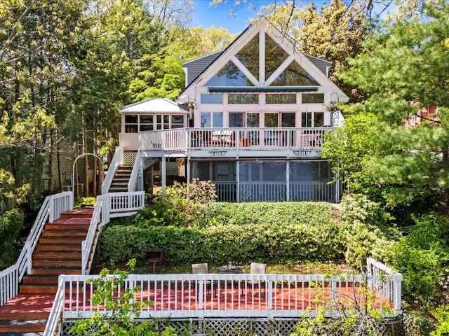 91 Lake Shore Dr, West Brookfield, MA 01585 - rear view of property with stairway, a deck, and a sunroom
