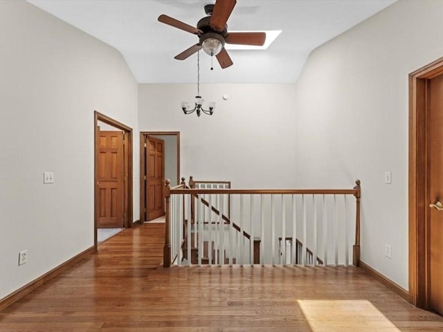91 Lake Shore Dr, West Brookfield, MA 01585 - hall featuring an upstairs landing, vaulted ceiling, wood finished floors, a chandelier, and baseboards