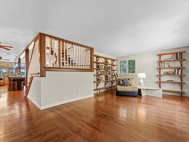 91 Lake Shore Dr, West Brookfield, MA 01585 - sitting room with stairs, wood finished floors, ceiling fan, and baseboards