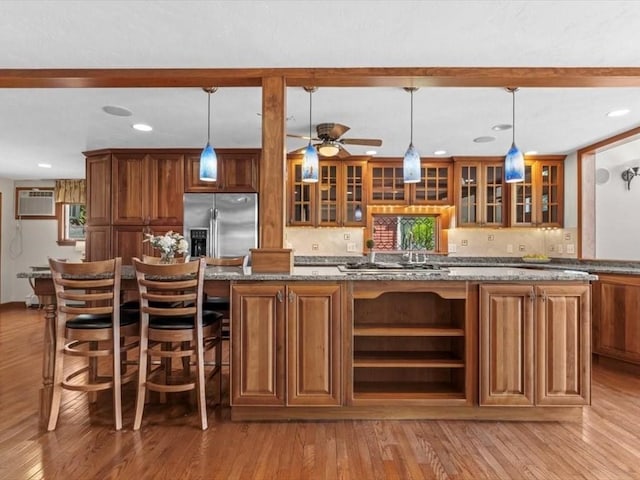 91 Lake Shore Dr, West Brookfield, MA 01585 - bar with appliances with stainless steel finishes, light wood-style flooring, recessed lighting, decorative backsplash, and pendant lighting