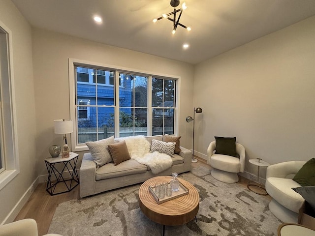 living room featuring a chandelier and wood-type flooring