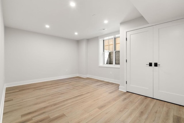 unfurnished bedroom featuring a closet and light wood-type flooring