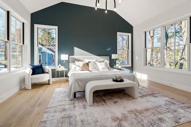 bedroom with light wood-type flooring and multiple windows