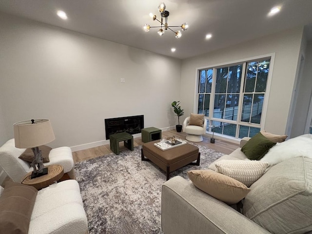 living room featuring a chandelier and hardwood / wood-style floors