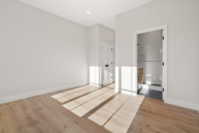 unfurnished bedroom featuring a closet and light hardwood / wood-style floors