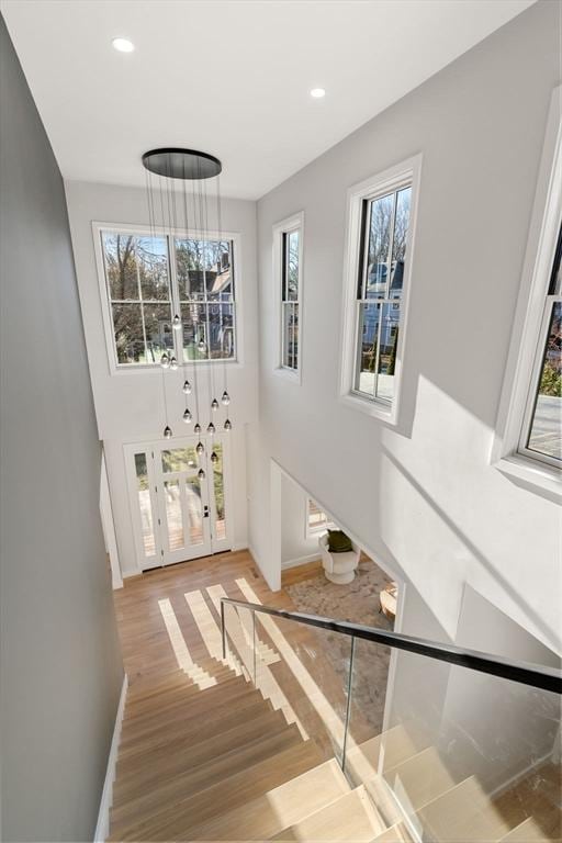 staircase with hardwood / wood-style floors and a wealth of natural light