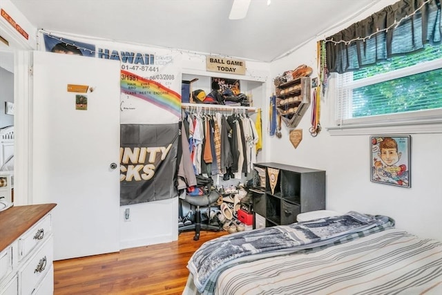 bedroom featuring a closet, a ceiling fan, and wood finished floors