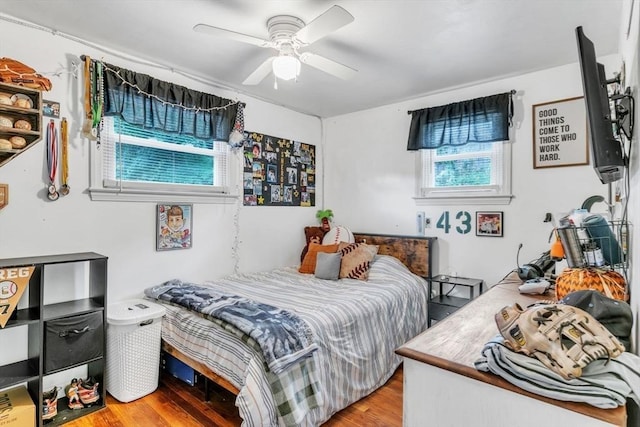 bedroom with a ceiling fan and wood finished floors