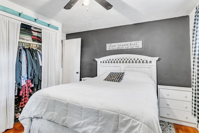 bedroom featuring a ceiling fan, a closet, and wood finished floors