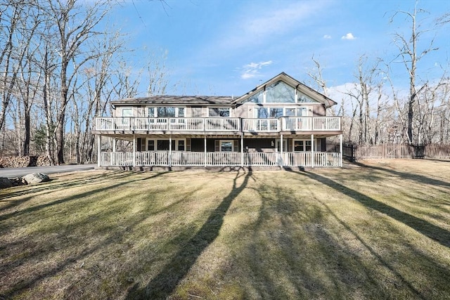 view of front of house with a deck and a front yard